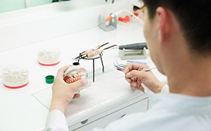 A dental technician working on dentures