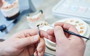 A lab worker creating dentures