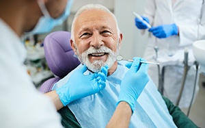 A happy senior man enjoying his new dentures