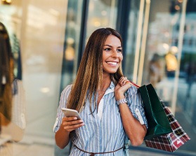 Woman smiling while shopping outsid