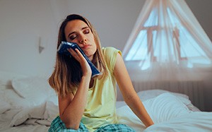 Woman with a cold compress on her cheek