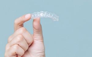 Closeup of patient holding clear aligner
