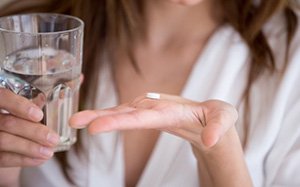 Lady prepares to take pill