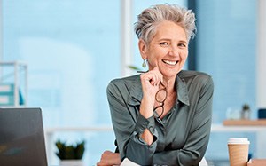 Woman smiling at her work desk