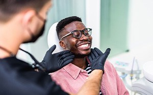 Dentist looking at smiling patient's teeth