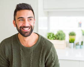 smiling man wearing a green sweater