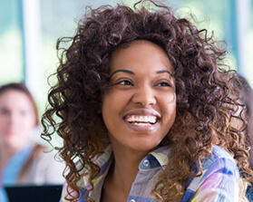 woman with curly hair smiling