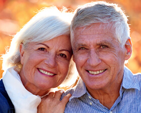 husband and wife smiling