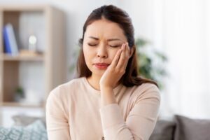 Woman experiencing TMJ pain