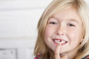 little girl with missing tooth