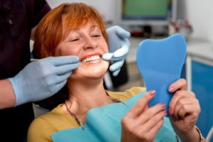 A woman viewing her dental implants.