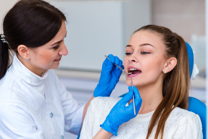 a young woman having her teeth checked