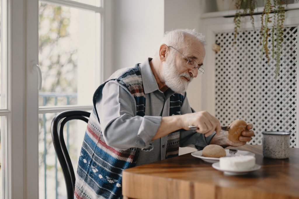 man eating with dentures in Bothell