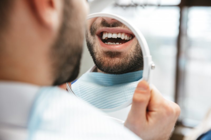 Man smiling with his dental implants